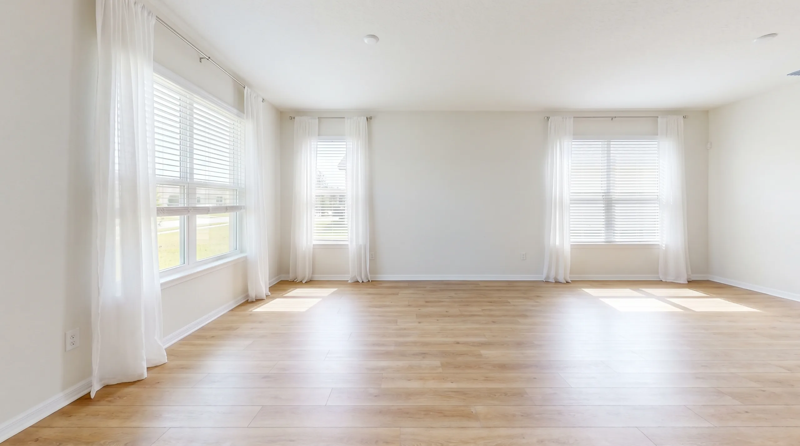 Photorealistic wide shot of an impeccably fresh, bright, standard middle-class American living room. Clean luxury vinyl plank flooring, standard windows with open blinds letting in abundant Florida sunlight and a gentle breeze blowing sheer white curtains. Represents a purified, odor-free environment. 8k resolution, completely empty, no people, no tools.